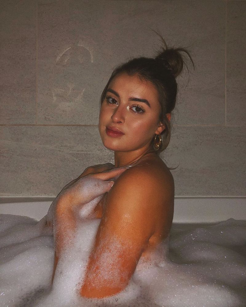 Kalani Hilliker naked in the bath covering her nude boobs with bubbles and ...
